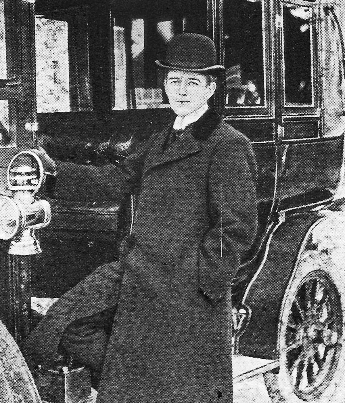 Francis standing beside his car